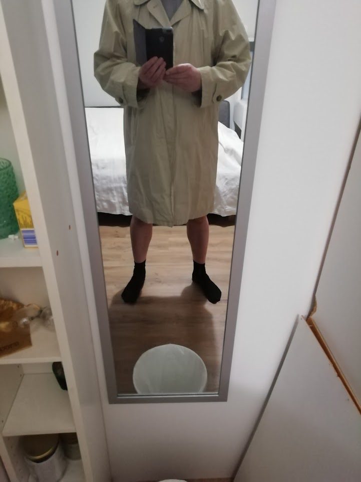Man in trench coat without trousers